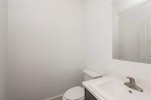 a white toilet sitting next to a white sink