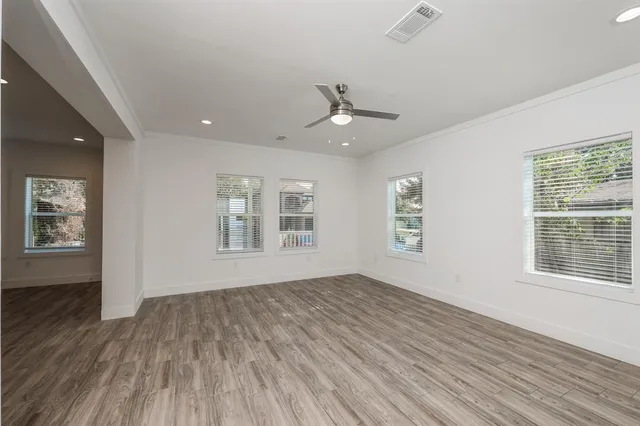 wooden floor in an empty room with a window