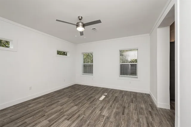 a view of a room with wooden floor and windows