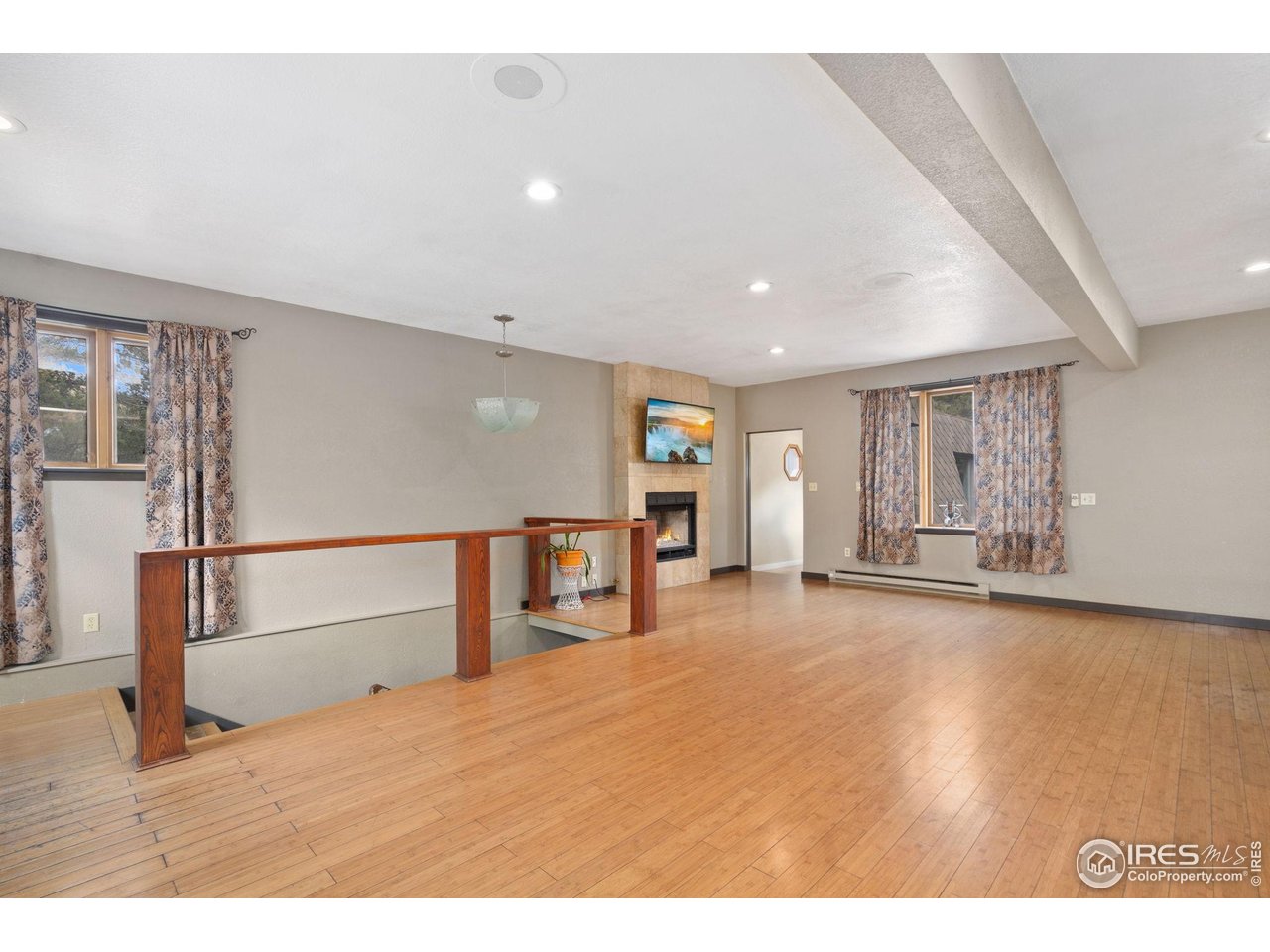 7301 Poudre Canyon Road Bellvue, CO 80512 - Photo 11 of 41 a view of an empty room with window and wooden floor