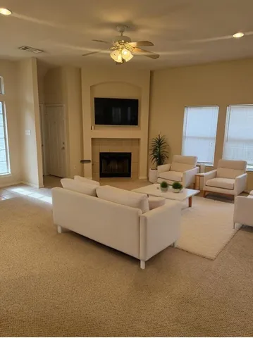 a living room with furniture and a fireplace