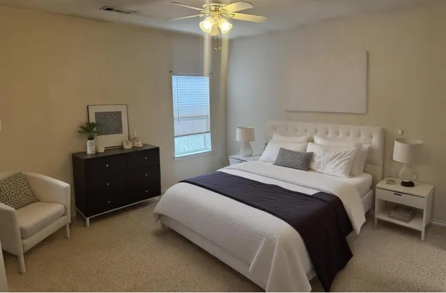 a bedroom with a bed and a chandelier