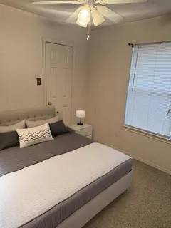 a bedroom with a bed and window