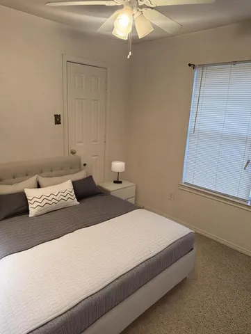 a bedroom with a bed and window