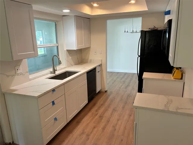 a kitchen with a sink and refrigerator