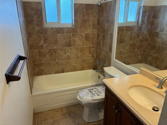 a bathroom with a sink a toilet and bathtub