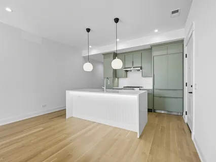 a view of a kitchen with a sink wooden floor and a window