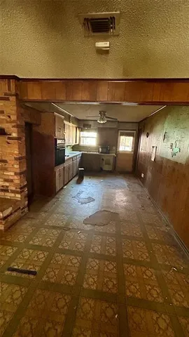 a large kitchen with a stove refrigerator and microwave