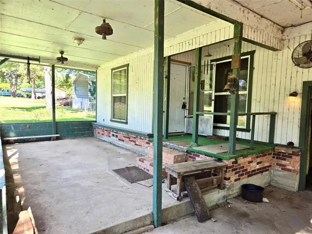 a view of a patio with table and chairs and potted plants