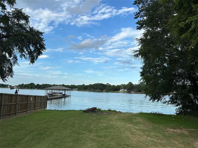 a view of a lake with houses in the back