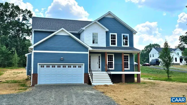 a view of a house with a yard and garage