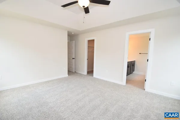 a view of an empty room with a ceiling fan