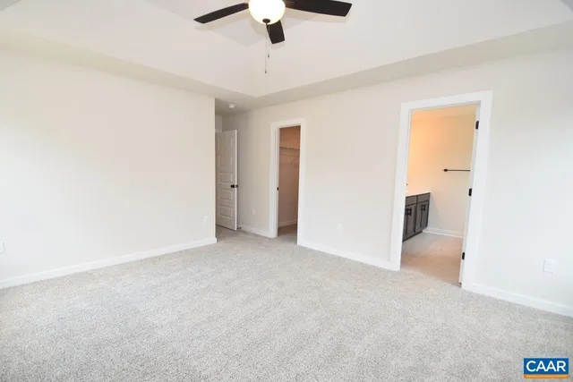 a view of an empty room with a ceiling fan