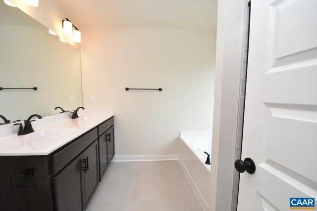 a bathroom with a double vanity sink a and a mirror