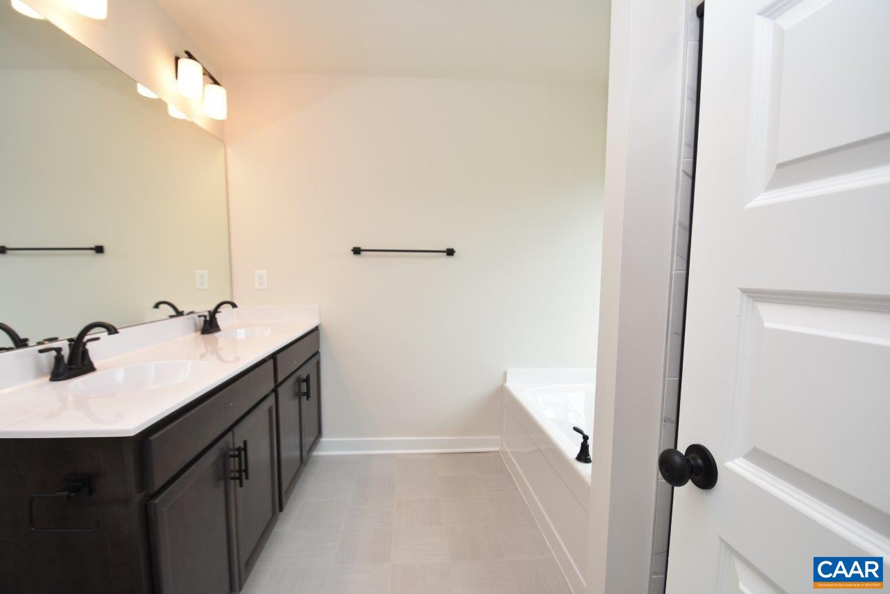0 Bybees Church Road, Unit BE 26A Palmyra, VA 22963 - Photo 30 of 39 a bathroom with a double vanity sink a and a mirror
