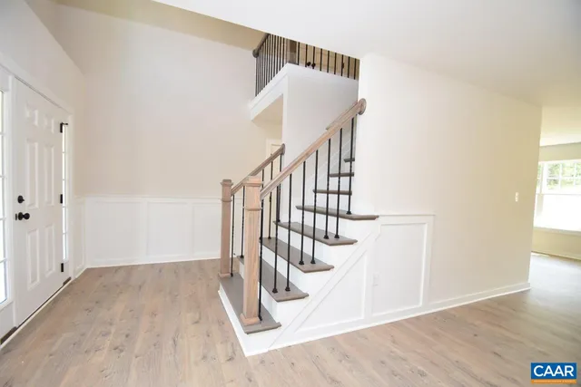 a view of entryway and hall with wooden floor