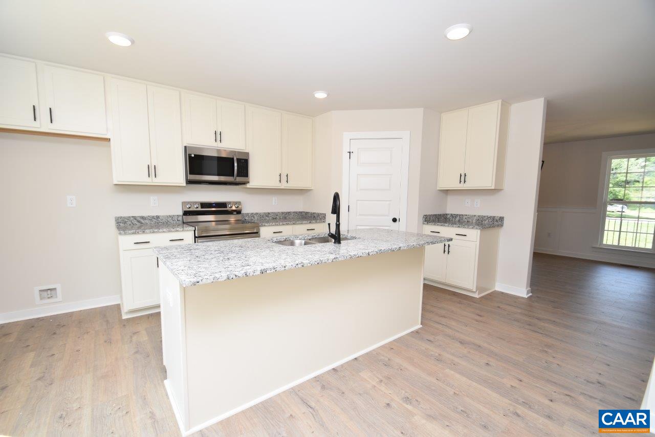 0 Bybees Church Road, Unit BE 26A Palmyra, VA 22963 - Photo 10 of 39 a kitchen with stainless steel appliances granite countertop a stove top oven a sink a refrigerator white cabinets and wooden floor