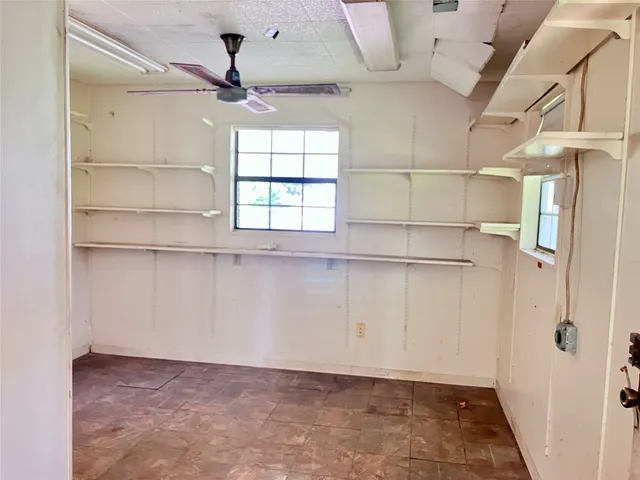 a view of a room with rack on the wall and a window