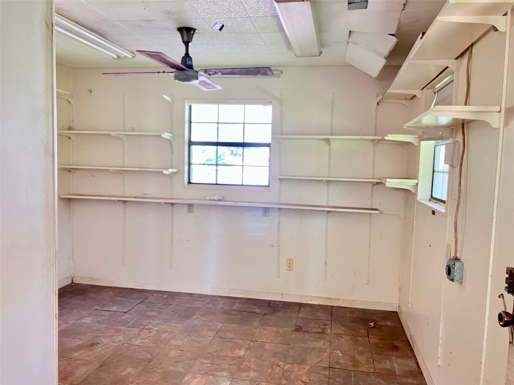 5012 Winding Way Dickinson, TX 77539 - Photo 16 of 24 a view of a room with rack on the wall and a window