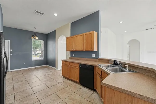 a kitchen with stainless steel appliances granite countertop a sink and a stove