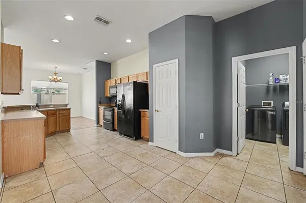 a kitchen with a refrigerator and a sink