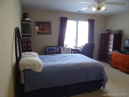 783 Knightswood Road Fort Mill, SC 29708 - Photo 14 of 17 a bedroom with a bed and dresser with mirror
