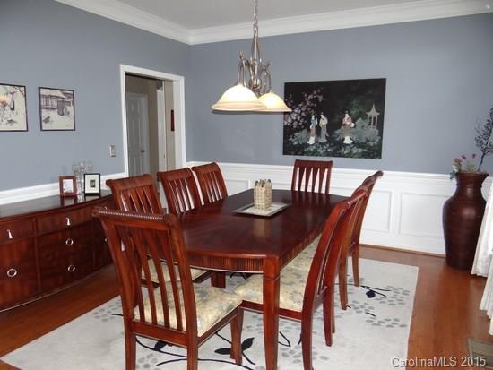 783 Knightswood Road Fort Mill, SC 29708 - Photo 3 of 17 a dining room with furniture a chandelier and wooden floor