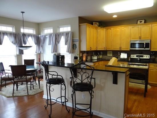 783 Knightswood Road Fort Mill, SC 29708 - Photo 4 of 17 a kitchen with a table chairs stove and cabinets