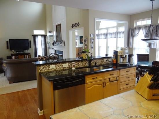 783 Knightswood Road Fort Mill, SC 29708 - Photo 7 of 17 a kitchen with stainless steel appliances granite countertop a sink and a stove