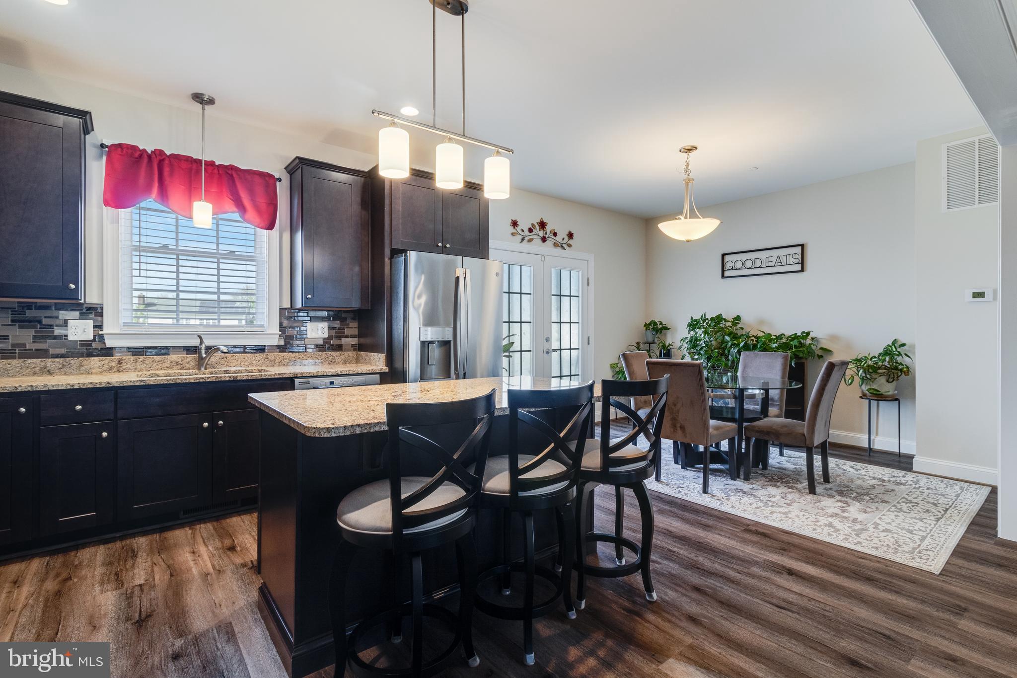 995 Rye Drive La Plata, MD 20646 - Photo 15 of 46 a open kitchen with stainless steel appliances granite countertop a dining table chairs stove a sink and dishwasher