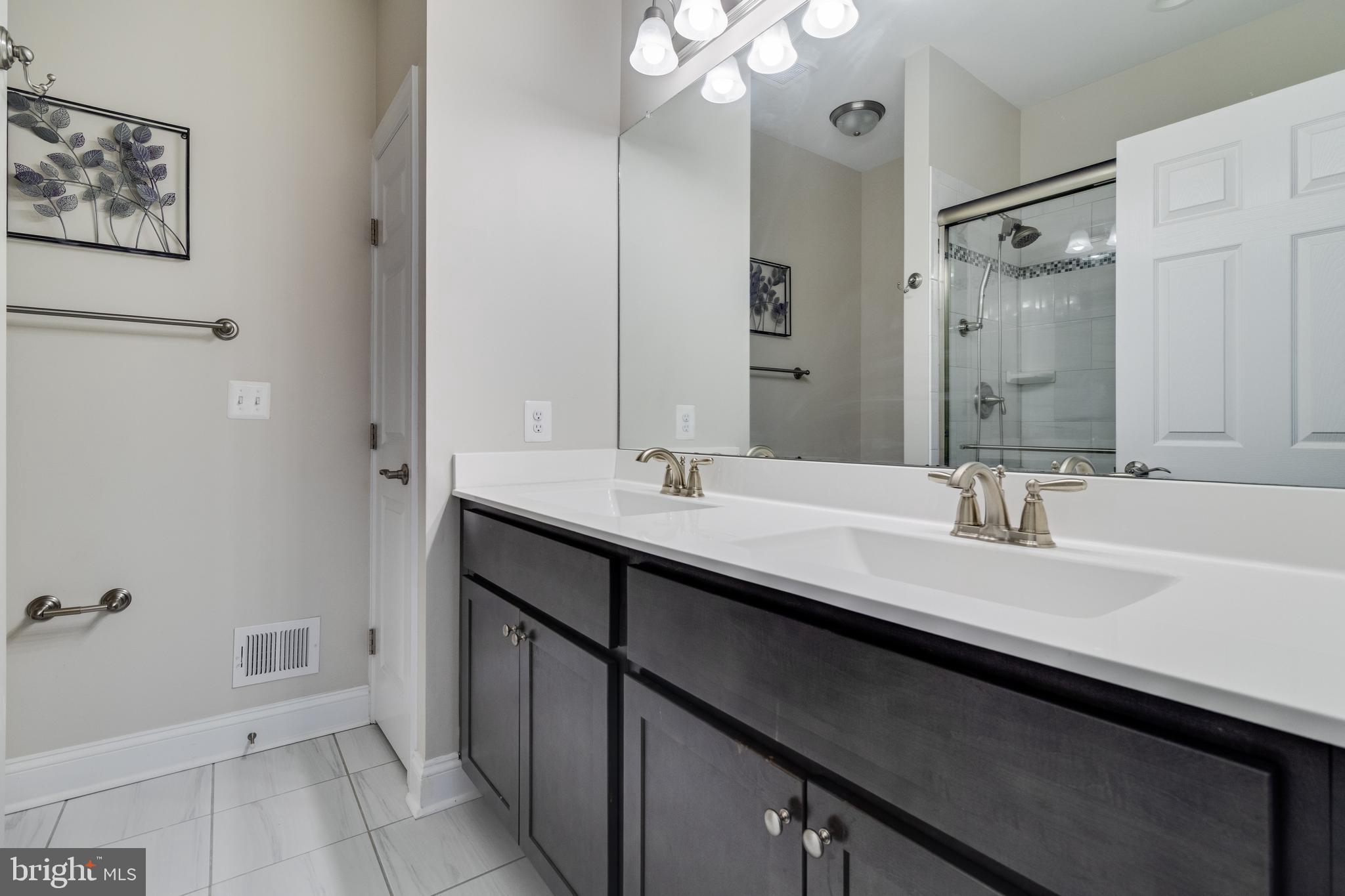 995 Rye Drive La Plata, MD 20646 - Photo 23 of 46 a bathroom with a sink a mirror and a shower