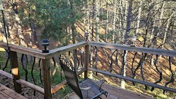 a view of a balcony with wooden floor and fence