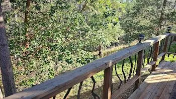 a balcony with wooden floor and wooden fence
