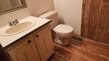 a bathroom with a toilet a sink and a mirror