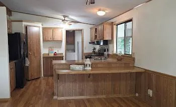 a dining room with kitchen island granite countertop furniture and a large window