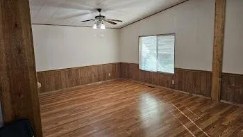 wooden floor in an empty room with a window