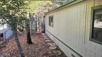 a view of a pathway of a house with wooden fence