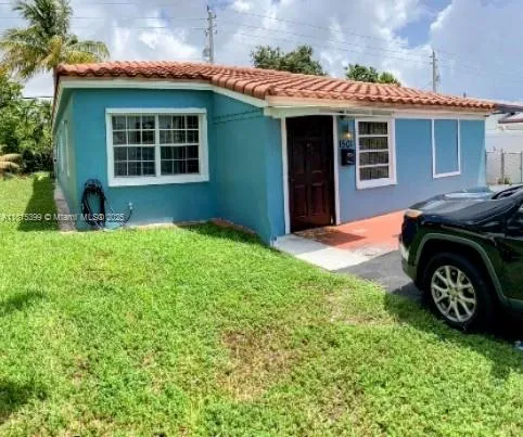 a front view of a house with a garden and yard