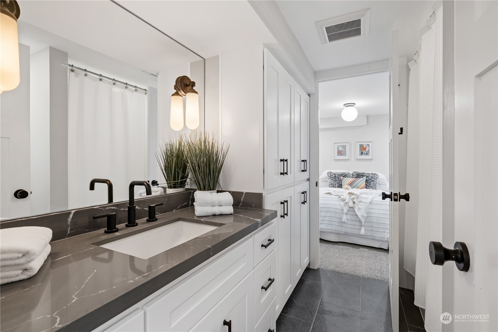 3541 Southwest 100th Street Seattle, WA 98146 - Photo 18 of 25 a spacious bathroom with a granite countertop sink and a mirror