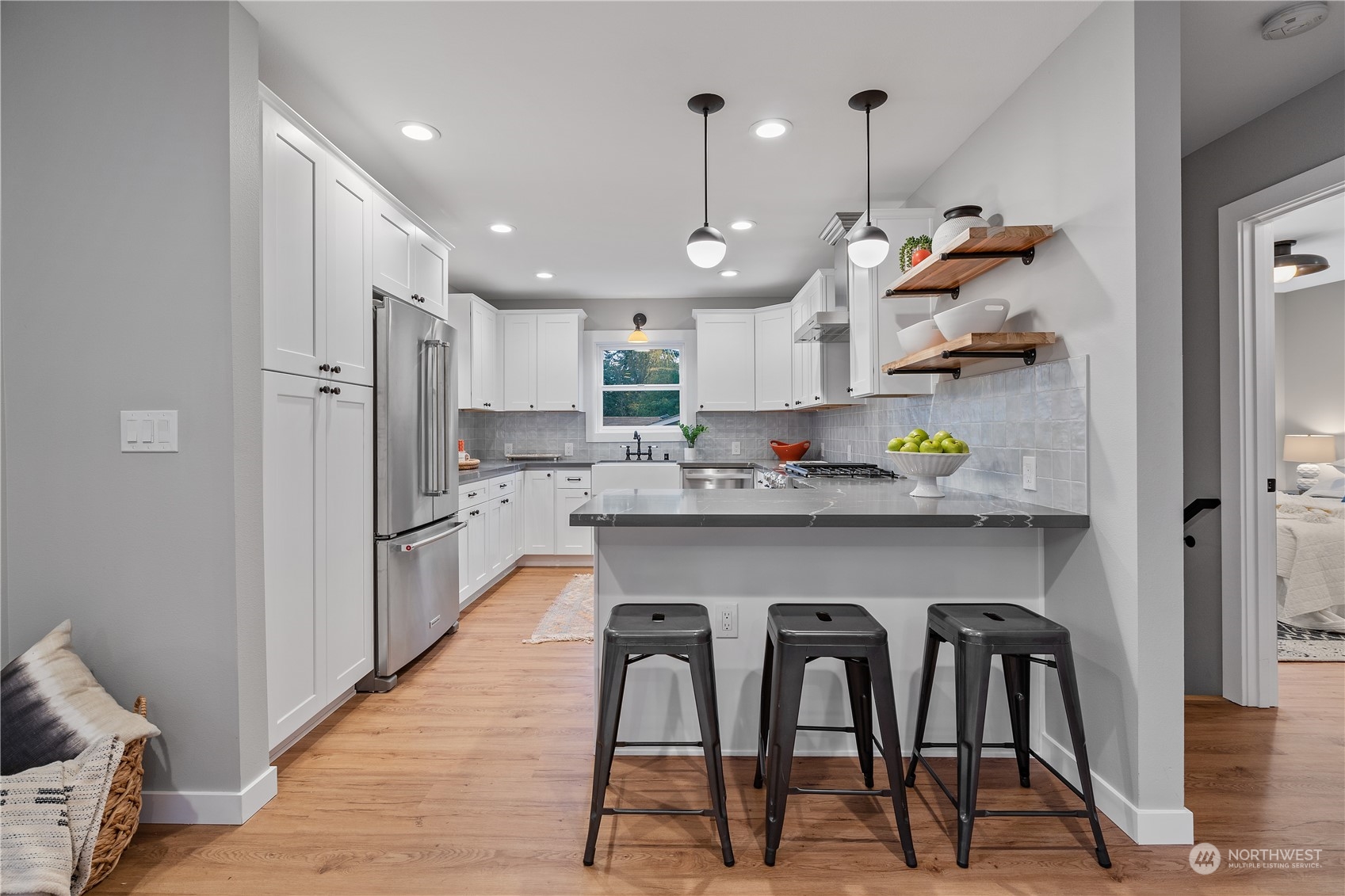 3541 Southwest 100th Street Seattle, WA 98146 - Photo 5 of 25 a kitchen with stainless steel appliances granite countertop a table chairs refrigerator and microwave
