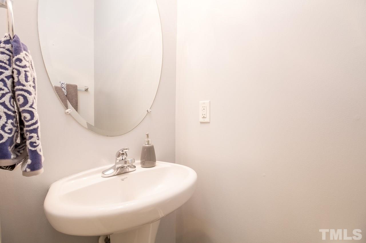 11701 Coppergate Drive, Unit 105 Raleigh, NC 27614 - Photo 11 of 25 Off the main entry, the powder room features a pedestal sink and tile floor.