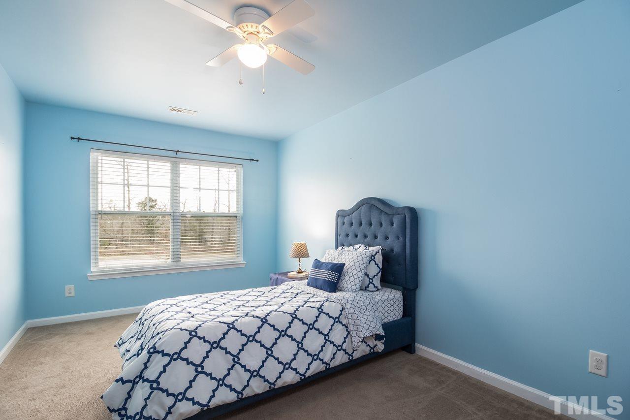 11701 Coppergate Drive, Unit 105 Raleigh, NC 27614 - Photo 13 of 25 One of the second floor bedrooms which features a double window, ceiling fan, and large walk-in closet.