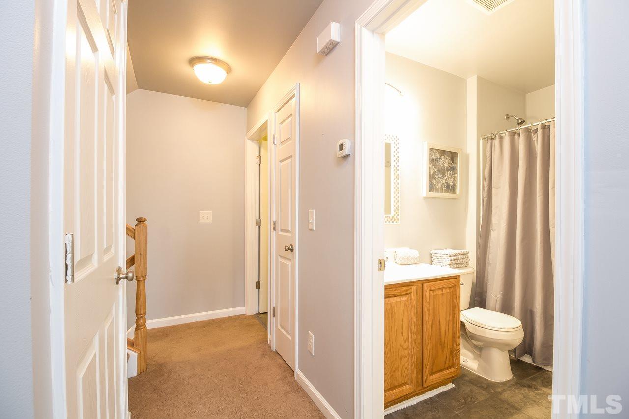 11701 Coppergate Drive, Unit 105 Raleigh, NC 27614 - Photo 16 of 25 A view of the second floor hallway which includes a linen closet, HVAC closet and the laundry room across from the stairs.