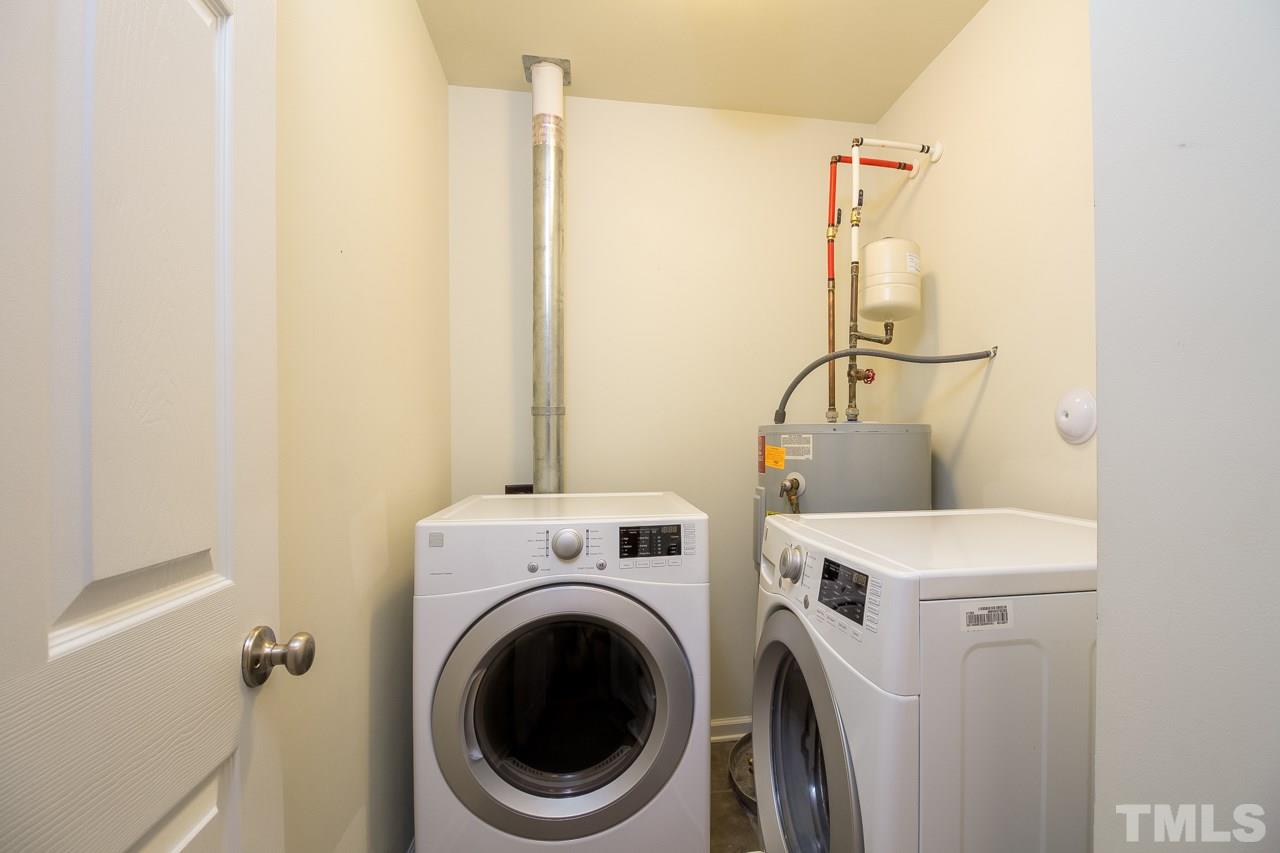 11701 Coppergate Drive, Unit 105 Raleigh, NC 27614 - Photo 18 of 25 The laundry room has a tile floor and also houses the electric water heater. Newer washer and dryer included!
