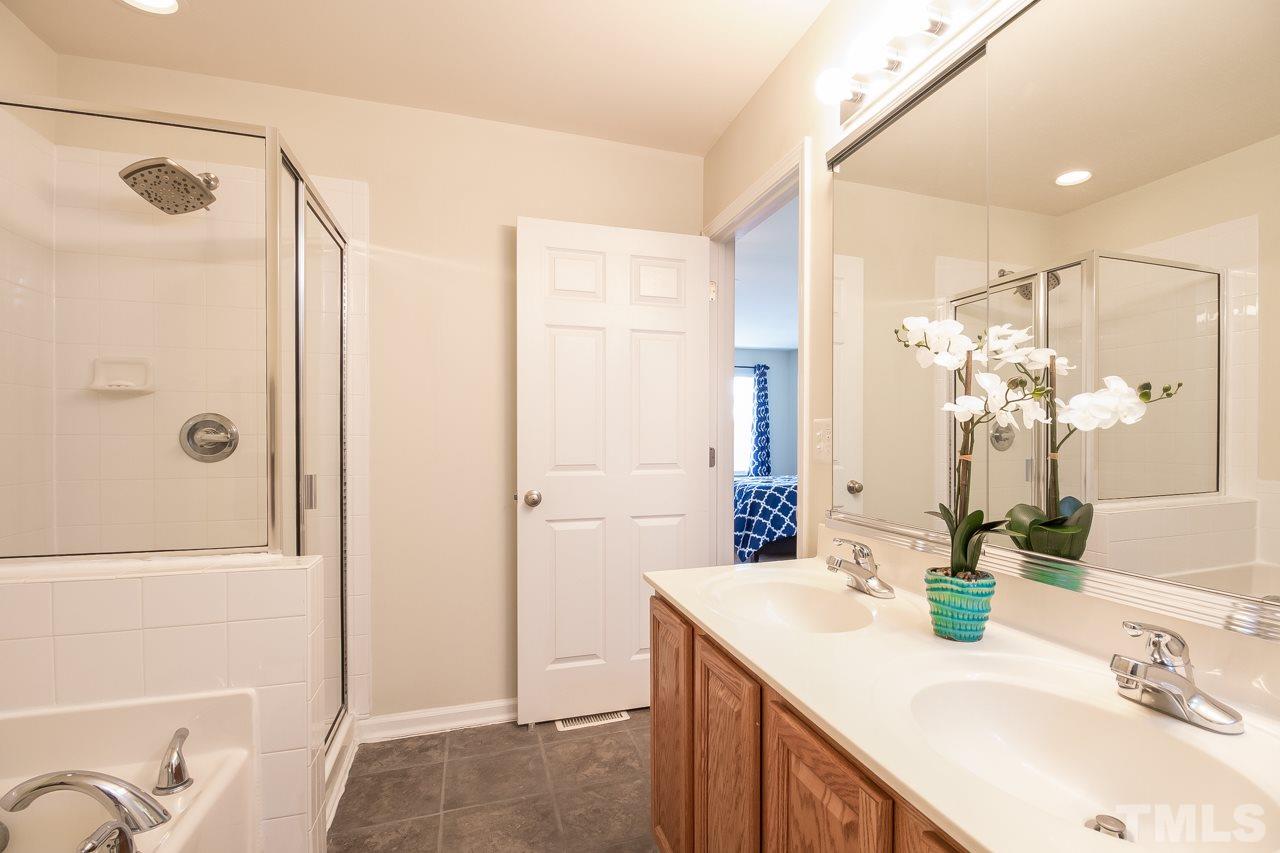 11701 Coppergate Drive, Unit 105 Raleigh, NC 27614 - Photo 22 of 25 Shower with glass enclosure and newer rain shower head. The soaking tub completes your spa experience - a great place to relax after a long day!