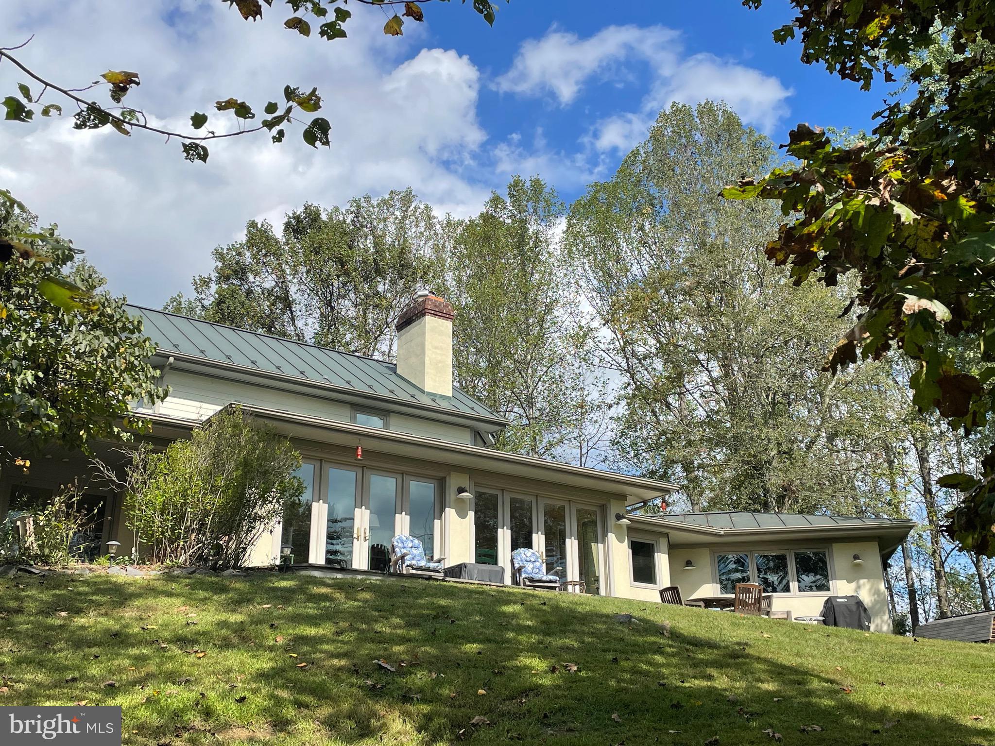 821 Long Mountain Road Washington, VA 22747 - Photo 2 of 24 a front view of a house with a garden