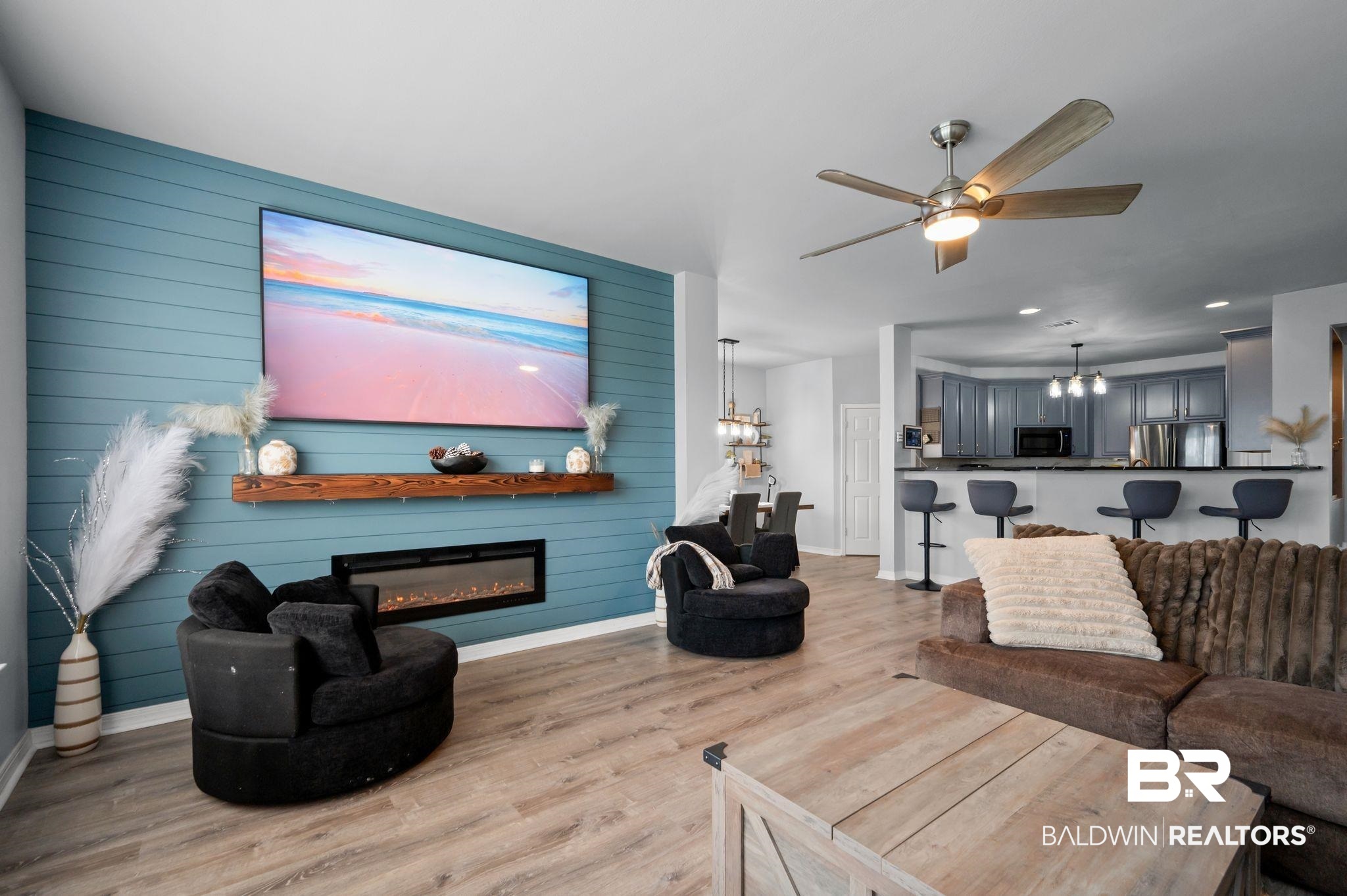1287 Pembroke Way Foley, AL 36535 - Photo 10 of 39 Living area with light wood-style flooring, a glass covered fireplace, ceiling fan, wooden walls, and suspended lighting