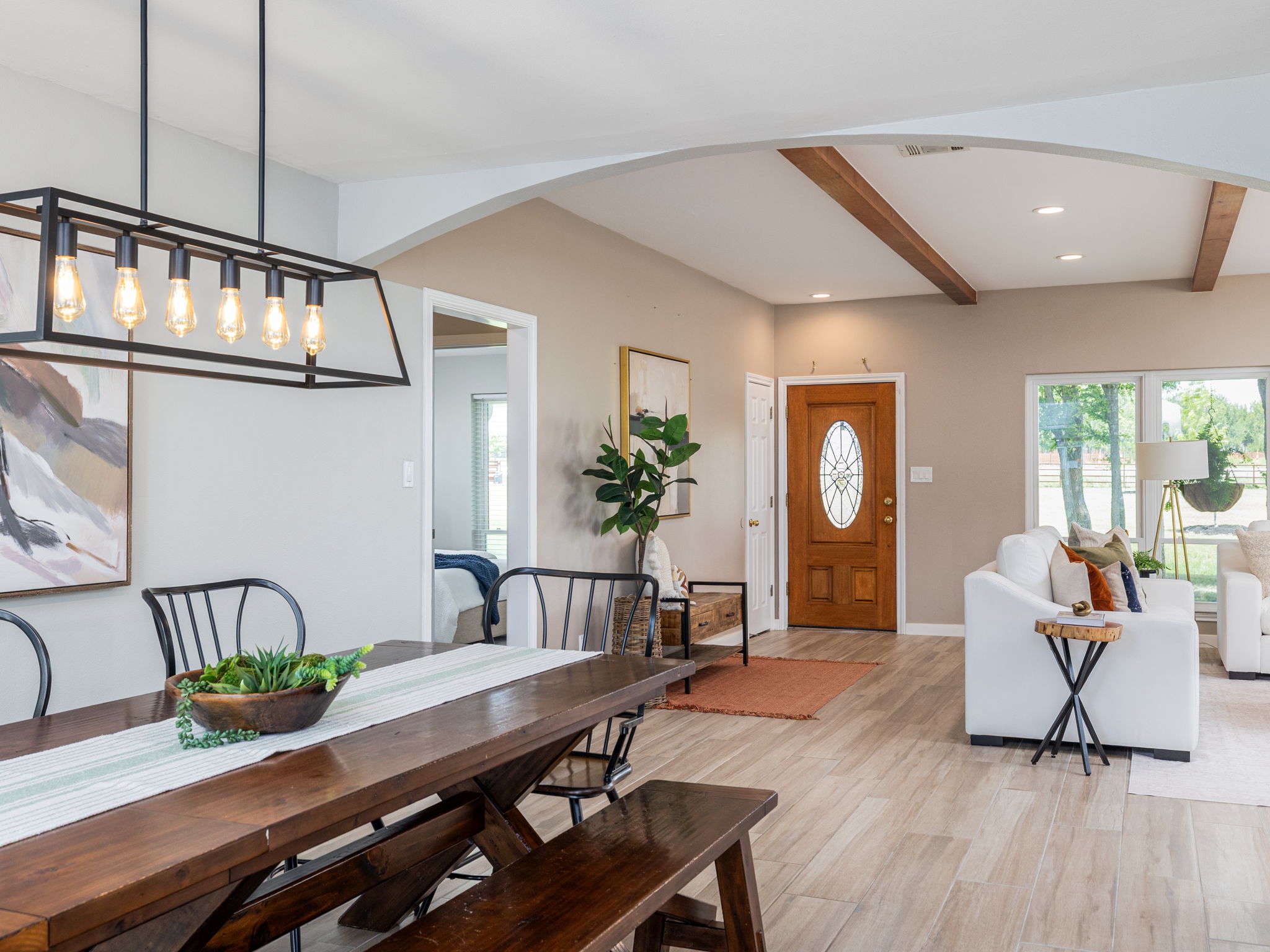 3001 County Road 255 Georgetown, TX 78633 - Photo 10 of 35 Archways and exposed wood beams define a spacious interior with modern lighting and durable tile flooring.