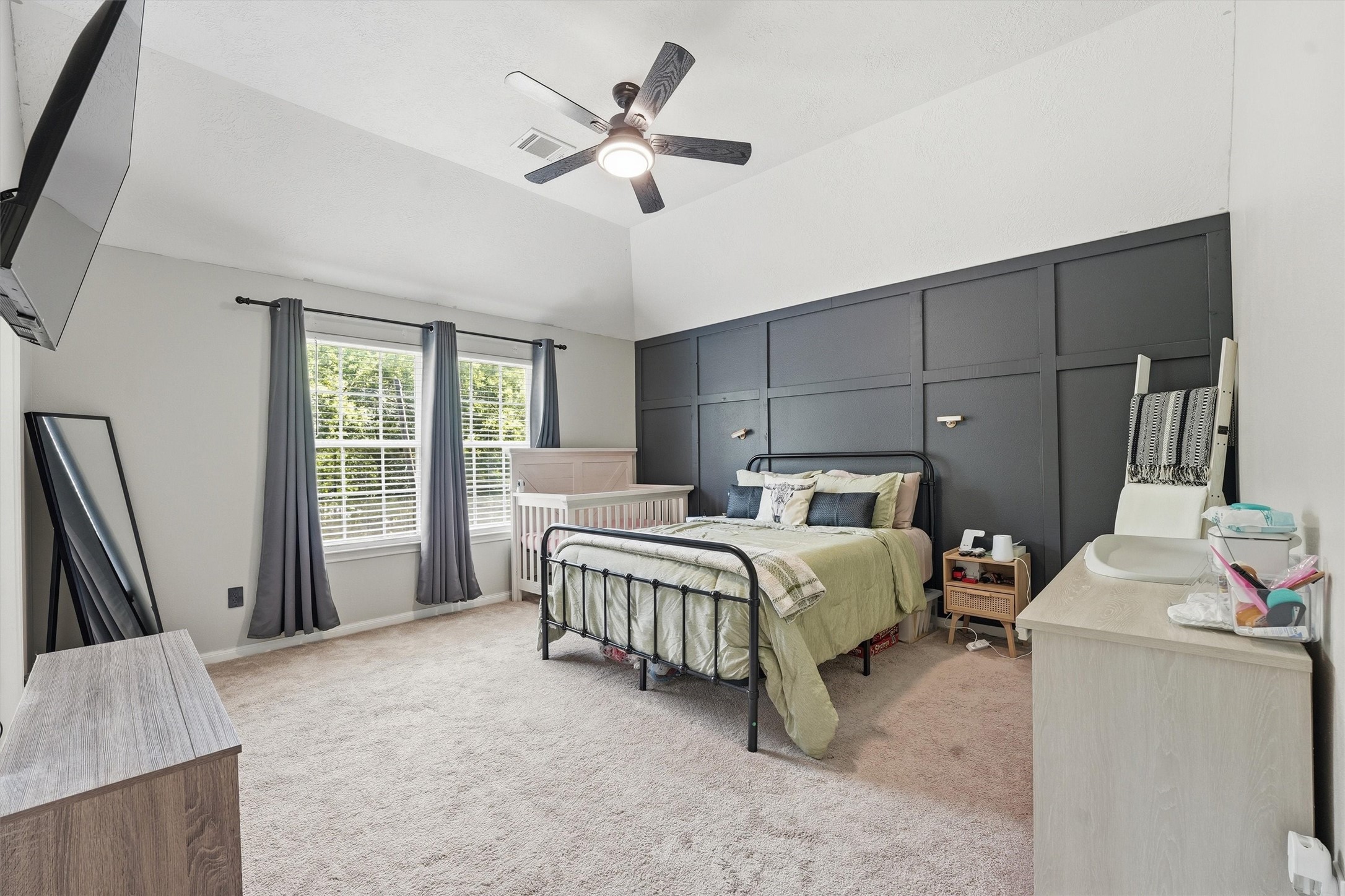 15011 Crockett Road Willis, TX 77378 - Photo 11 of 24 Primary suite featuring stylish accent wall and comfortable layout.