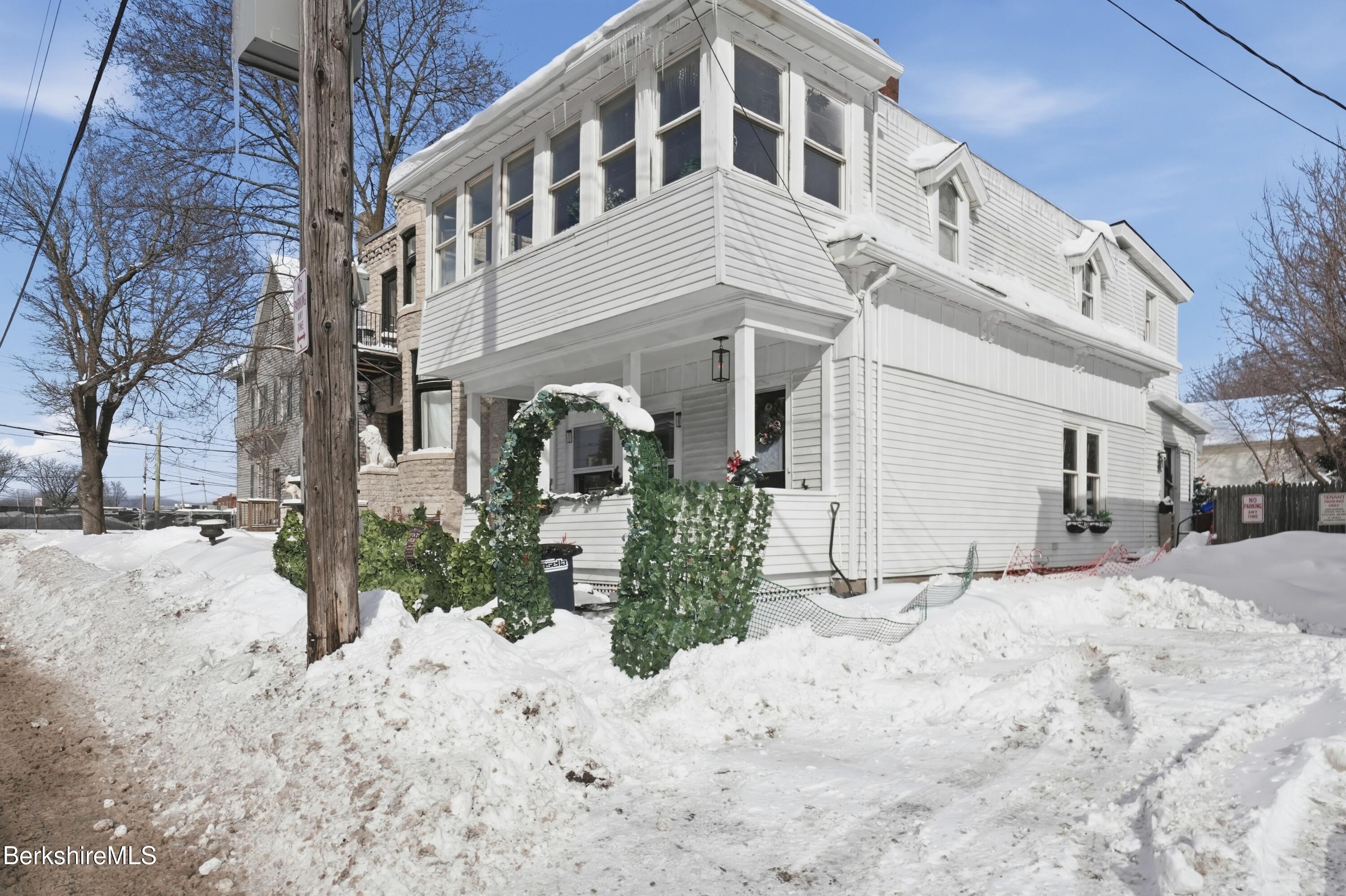 9 Lincoln Street Pittsfield, MA 01201 - Photo 1 of 44 a view of a house with a yard covered in snow